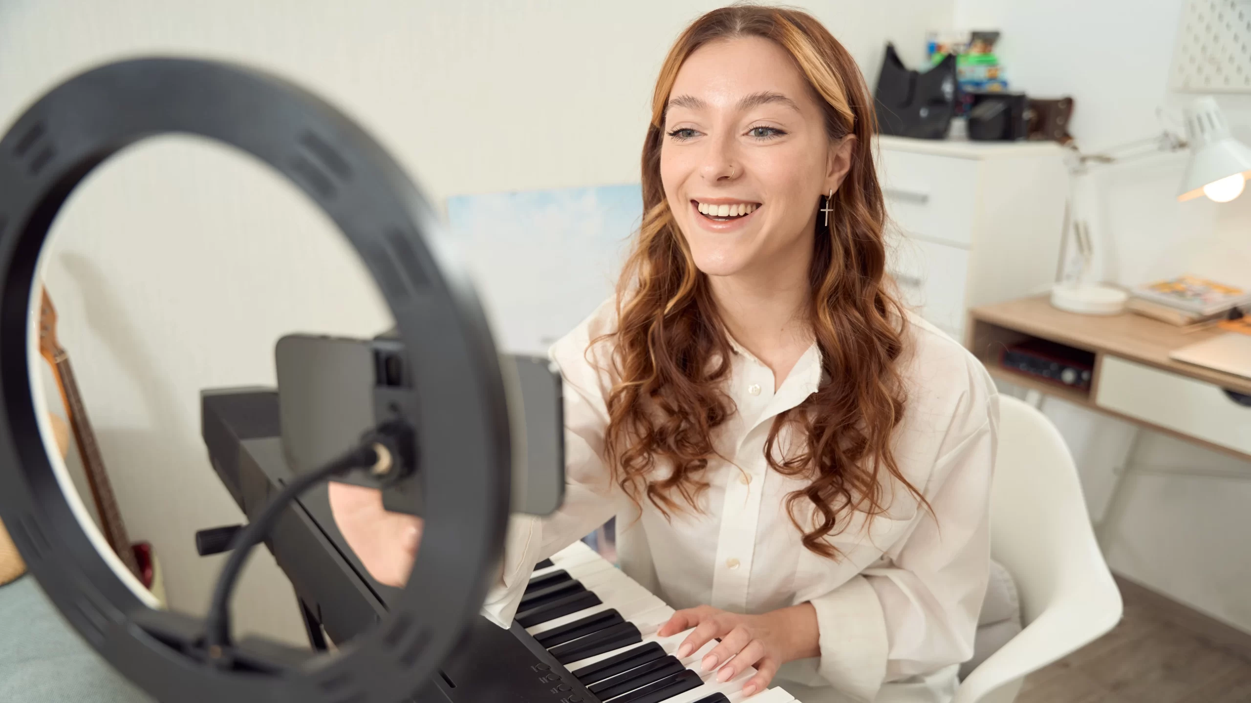 A woman recording herself playing the piano