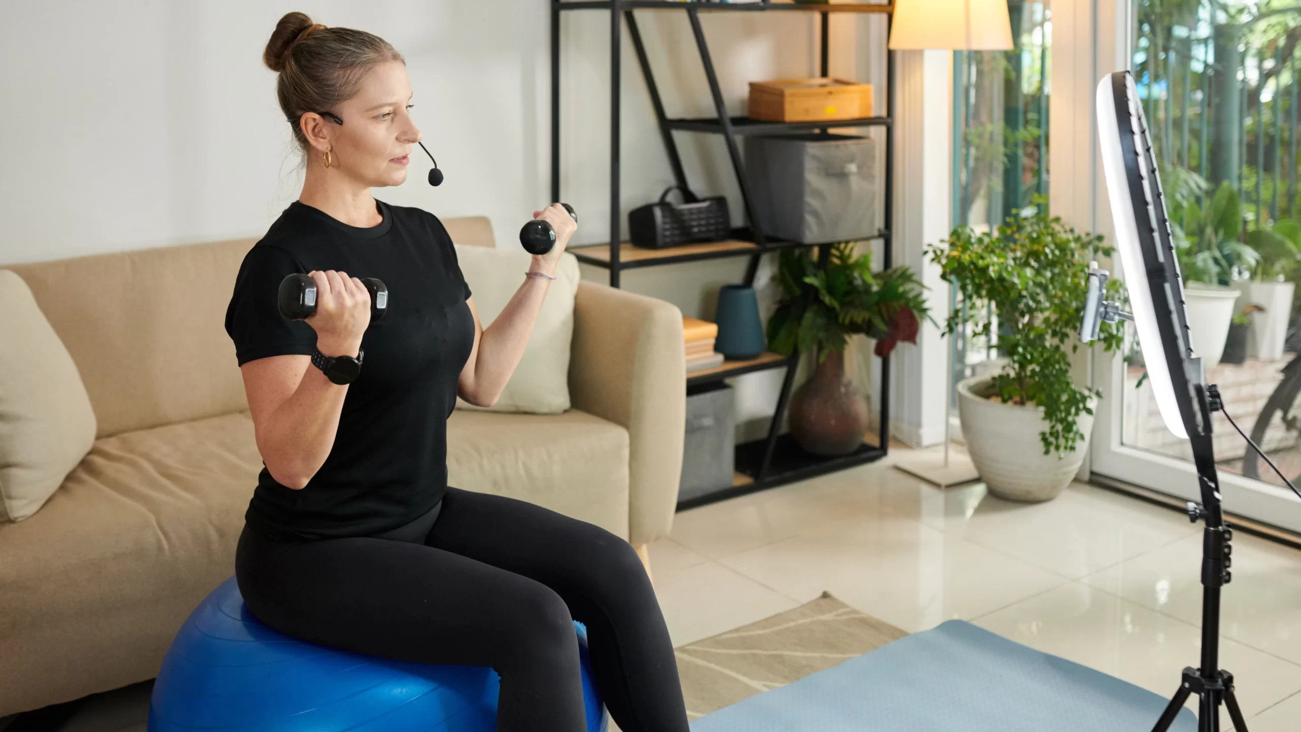 A woman recording herself doing an exercise routine