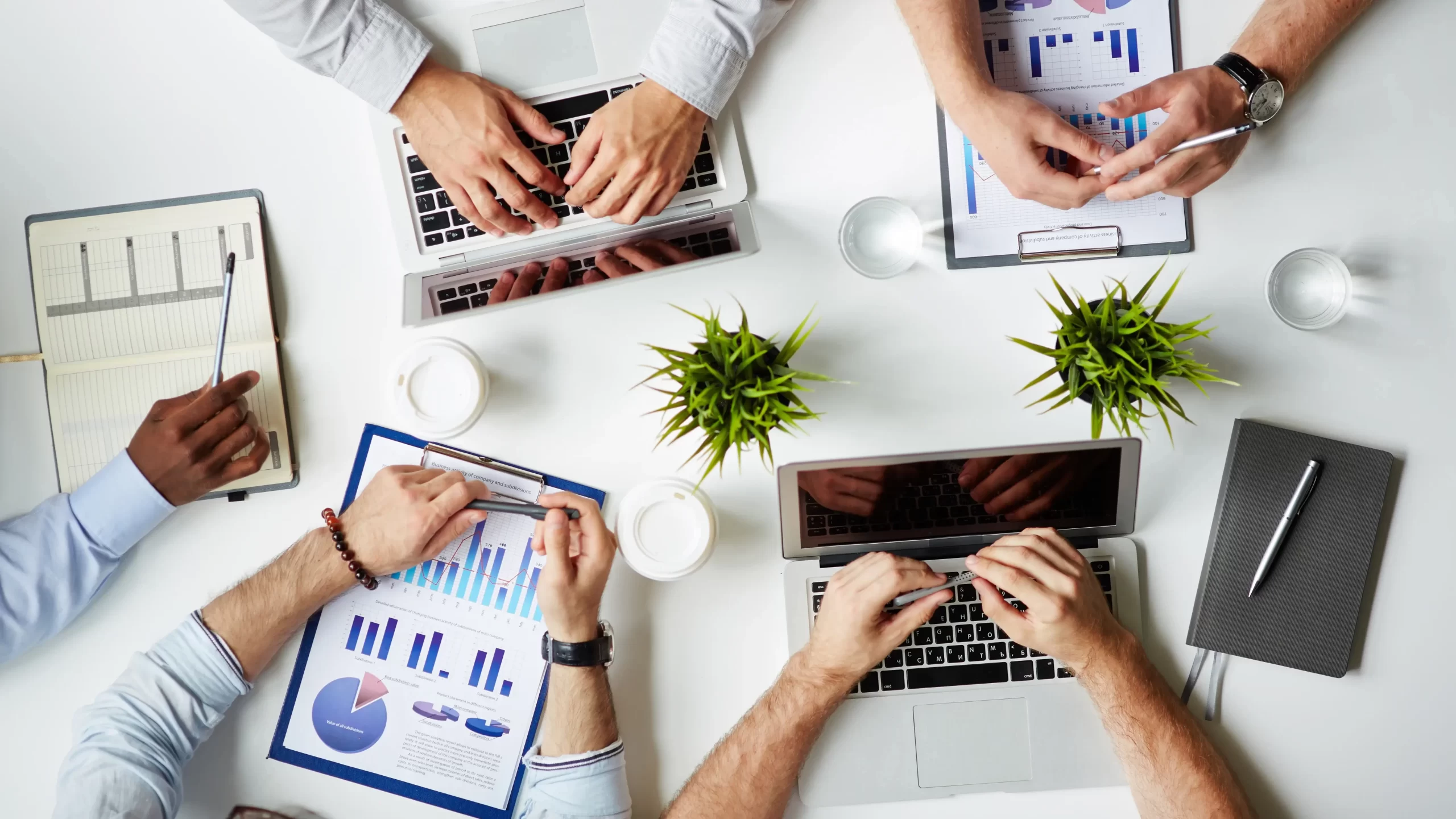 People at a table reviewing sales data